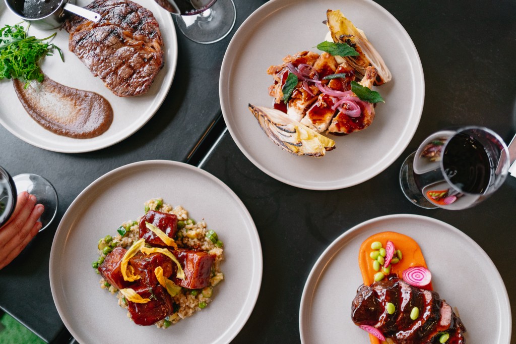 Different dishes plated at Seafire On The Marina, including steak.