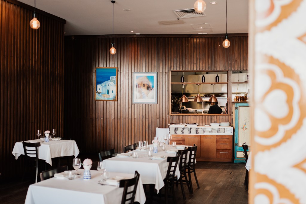 Interior shot of Ellenika Ocean Grill dining area, featuring wooden walls.