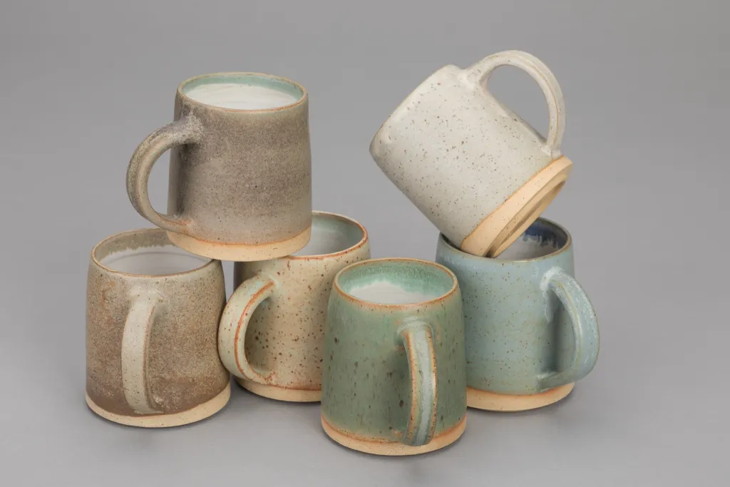 Mugs in earthy tones and textures.